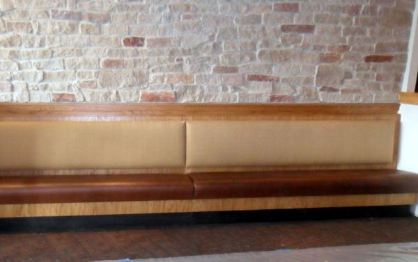 Fully upholstered banquette with oak wood tables